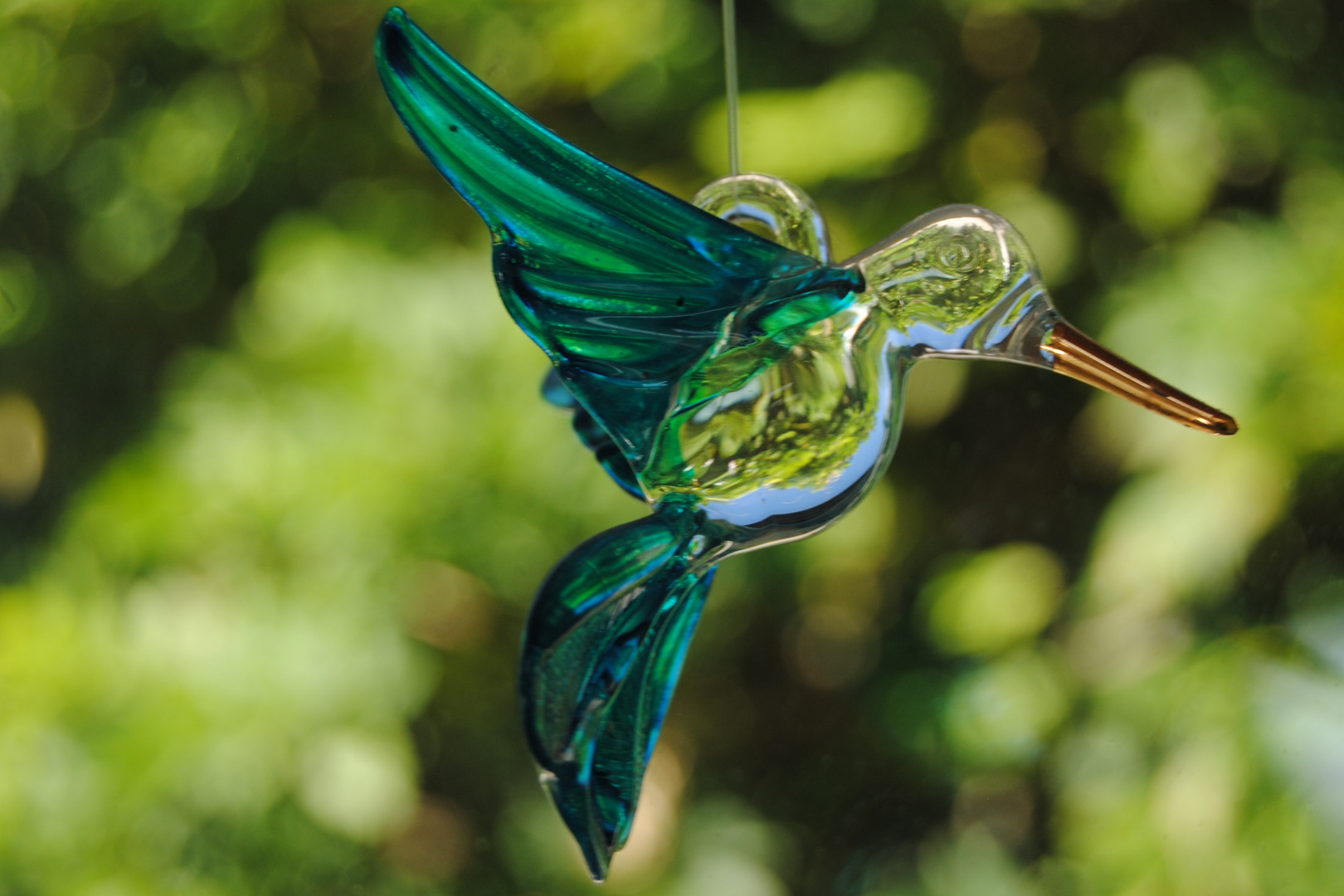 Glass bird on a green background