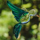 Glass bird on a green background