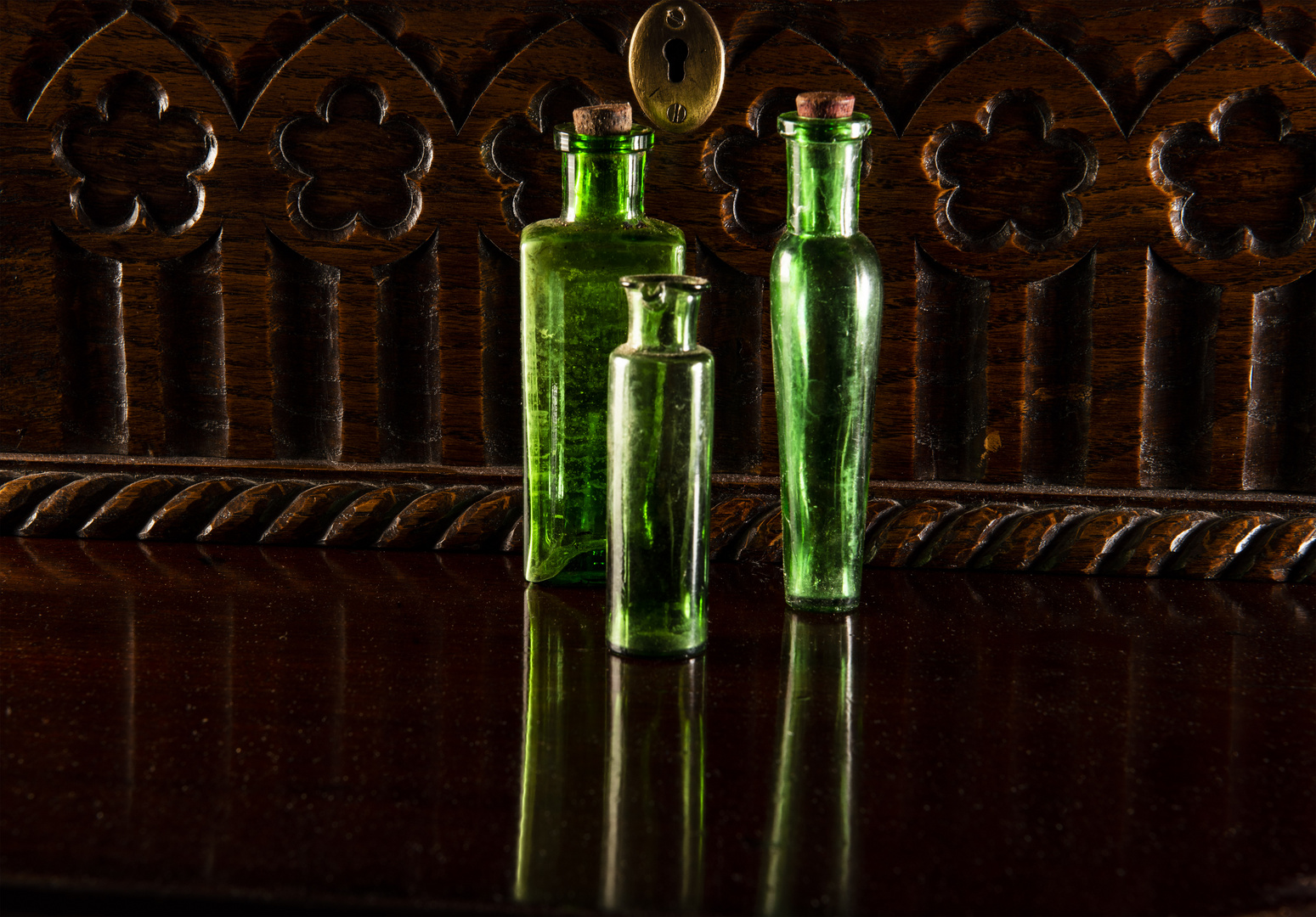 green bottles  on mahogany table