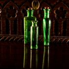green bottles  on mahogany table