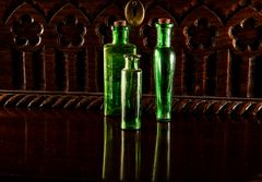 green bottles  on mahogany table