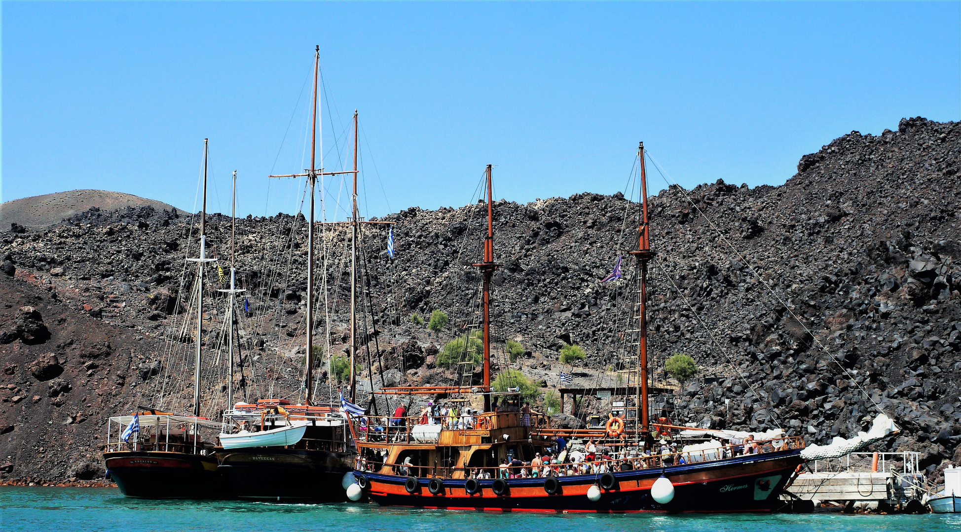 griechische Segler warten am Ufer der Insel Nea Kameni