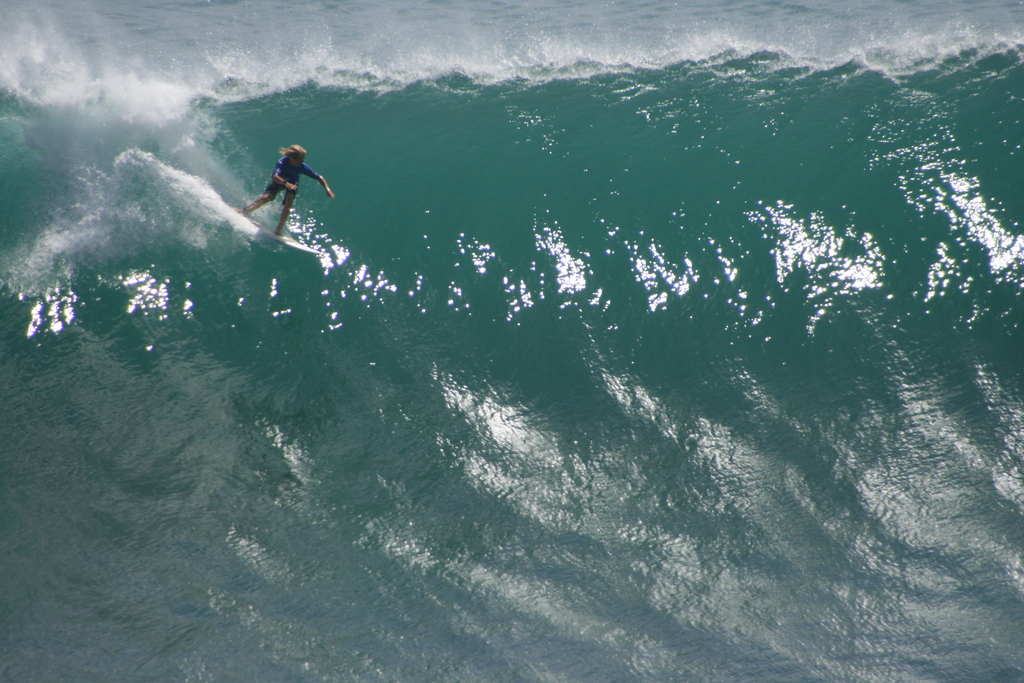 Grom taking off on massive Wave at Padang-Padang, Bali, Indonesia