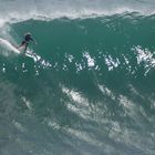Grom taking off on massive Wave at Padang-Padang, Bali, Indonesia