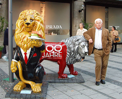 grumpy looking Bavarian standing with lions