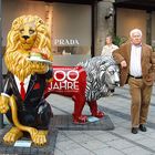 grumpy looking Bavarian standing with lions