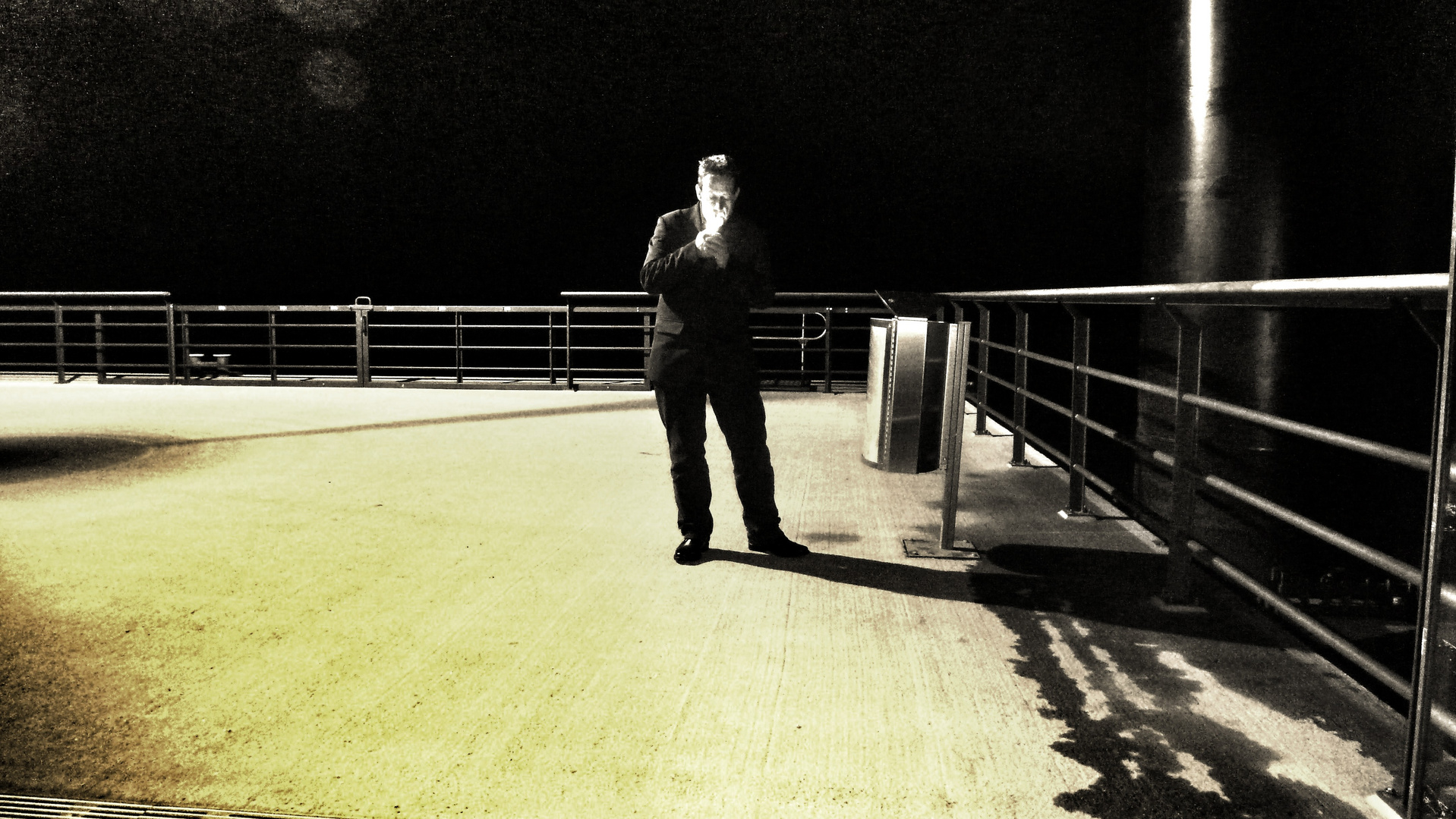 Guy Lighting a Cigarette on a Pontoon Bridge (Hamburg, September 2011)