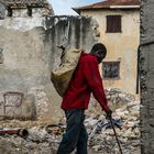 Haiti | Man walking through a building destroyed by an earthquake