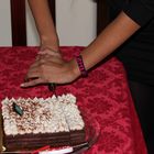 Hands cutting cake