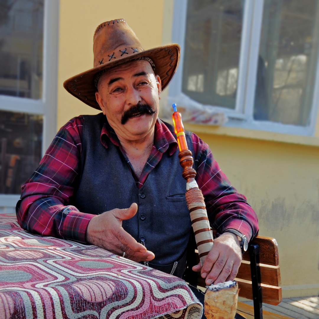 Happy cowboy smoking hookah