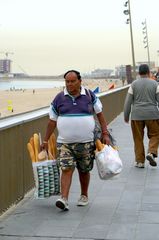 hungry man at barcelona beach