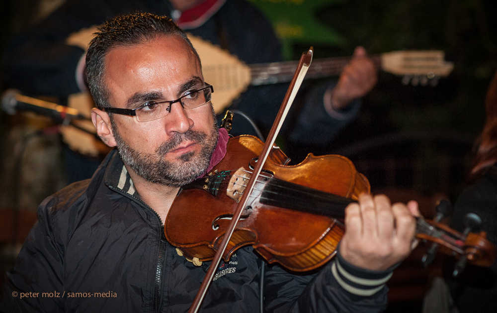 Ikaria/Greece - Nikos Fakaros playing during panigiri in Pezi