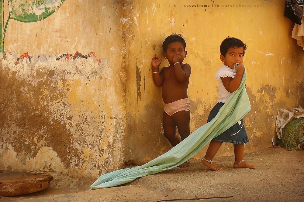 Indian children near yellow wall