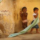 Indian children near yellow wall