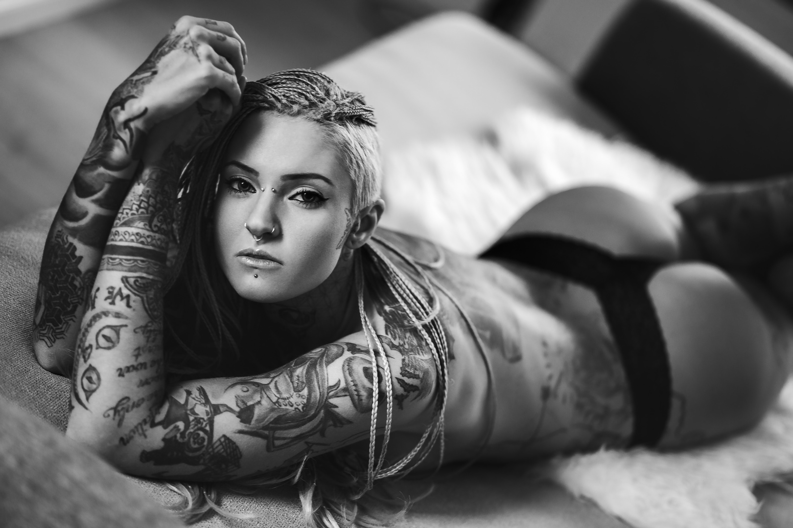 Inked girl on her bed.