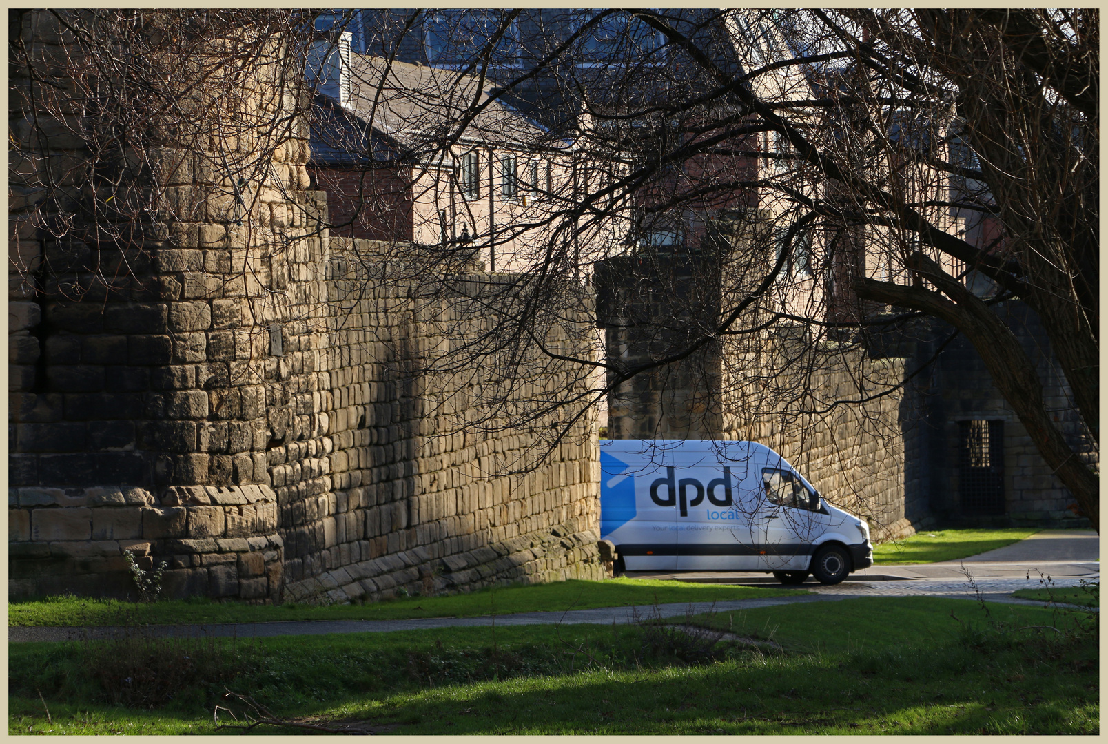 internet delivery van cutting through the medieval city walls of newcastle