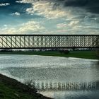 Iron bridge over muddy water