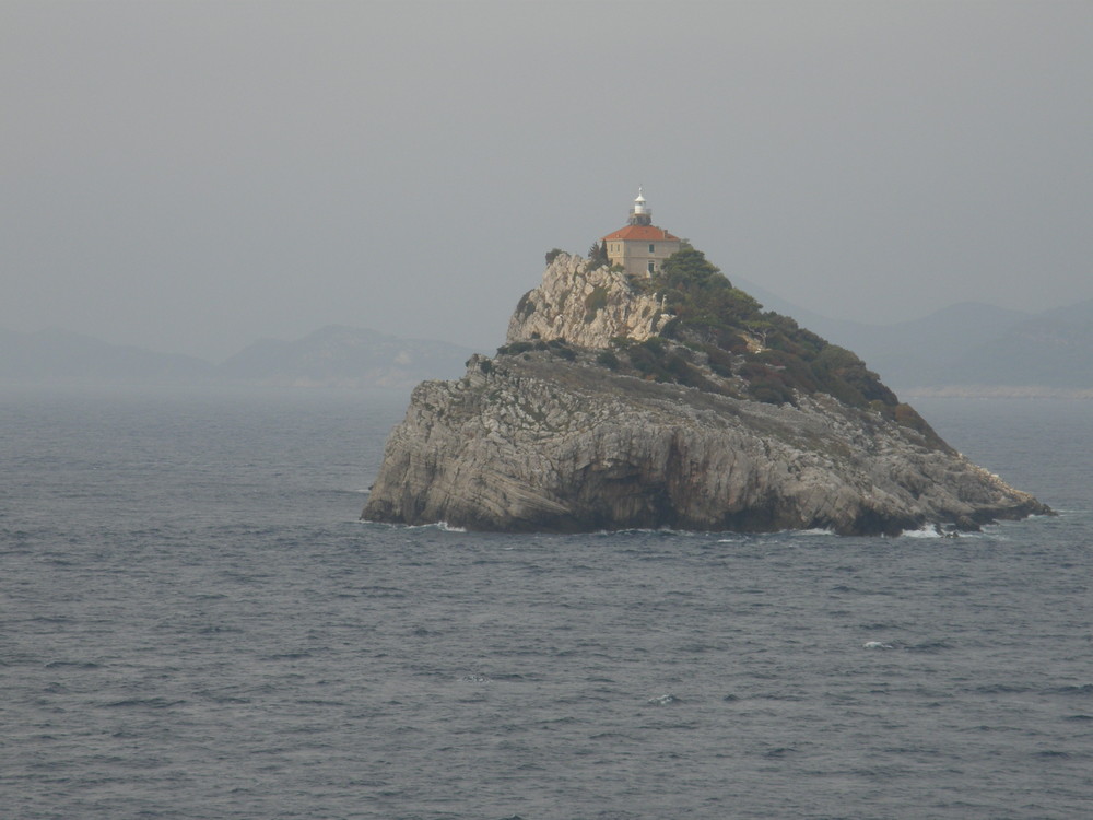 Isla Croata con faro. Isolated Croatia island.