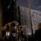 Israeli soldiers in Riot Gear as Arafat looks on from the separation wall