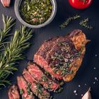 Juicy tender sous-vide grilled irish beef rump steak with fresh herbs