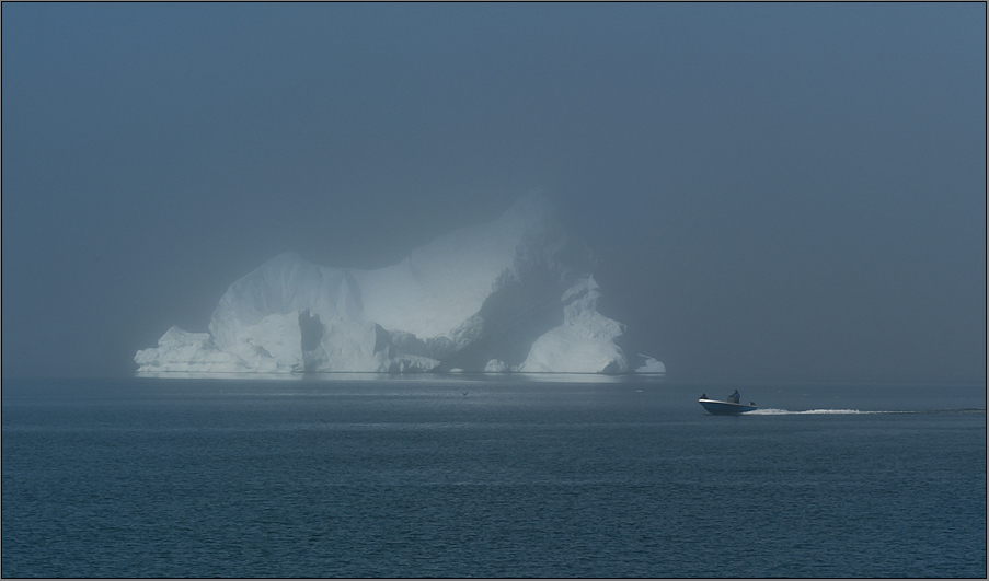 just another boat in front of an iceberg