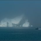 just another boat in front of an iceberg