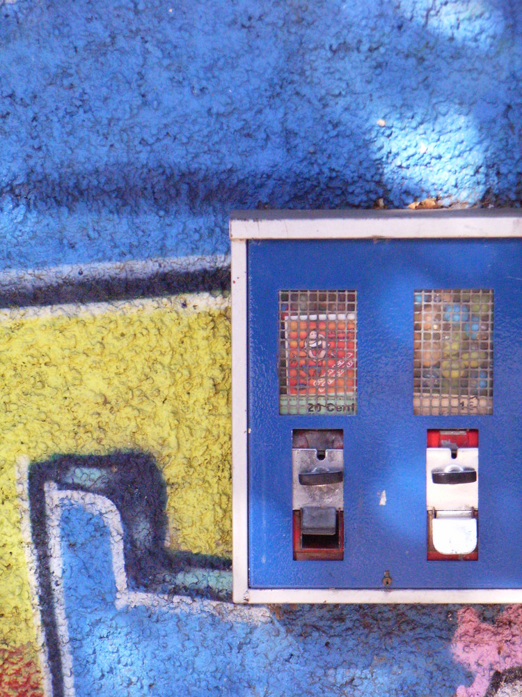 Kaugummiautomat vor Graffitiwand