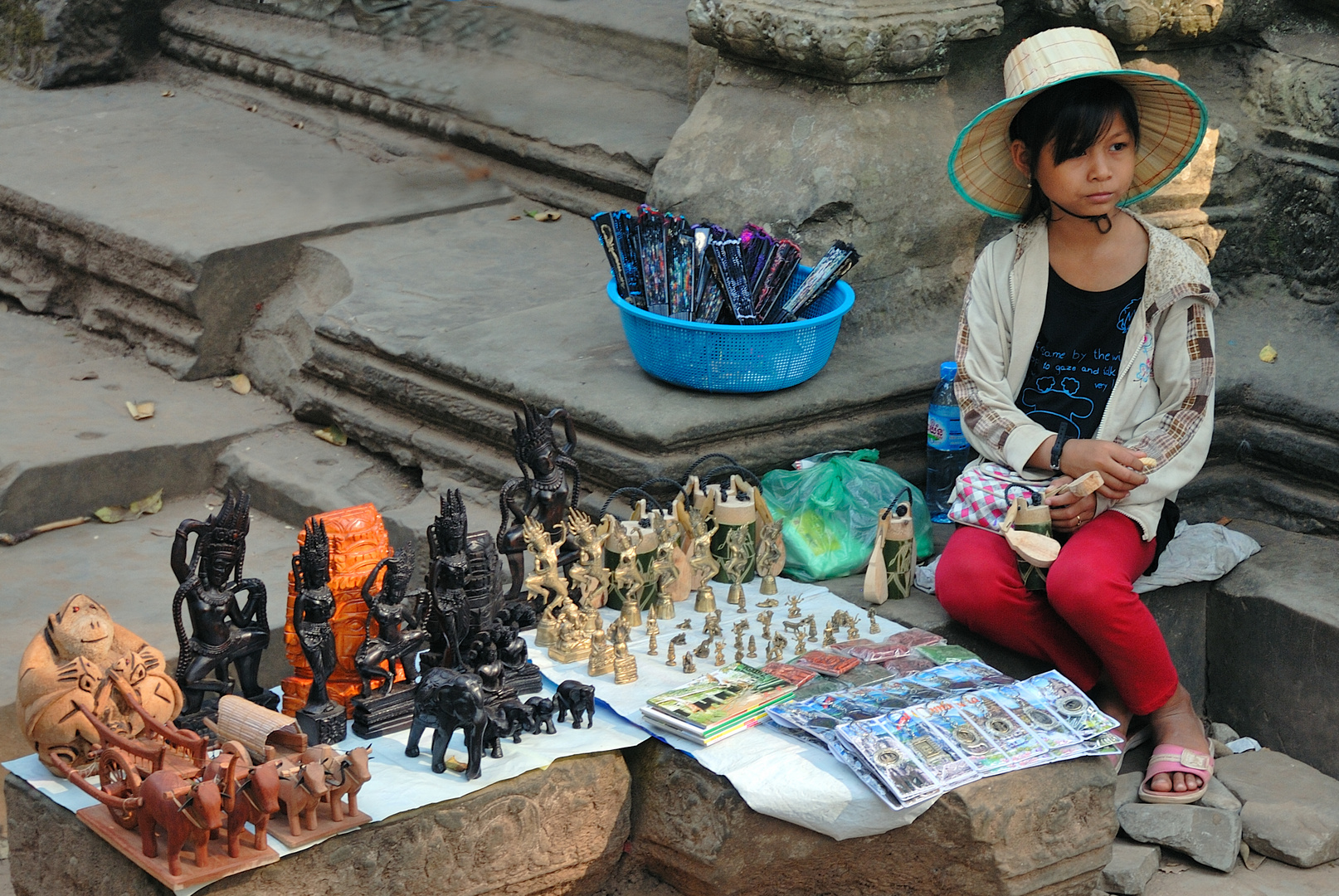 Khmer kid sells souvenir in Prasat Ta Prohm