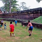 Kids are playing soccer in Prasat Muang Tam