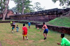 Kids are playing soccer in Prasat Muang Tam