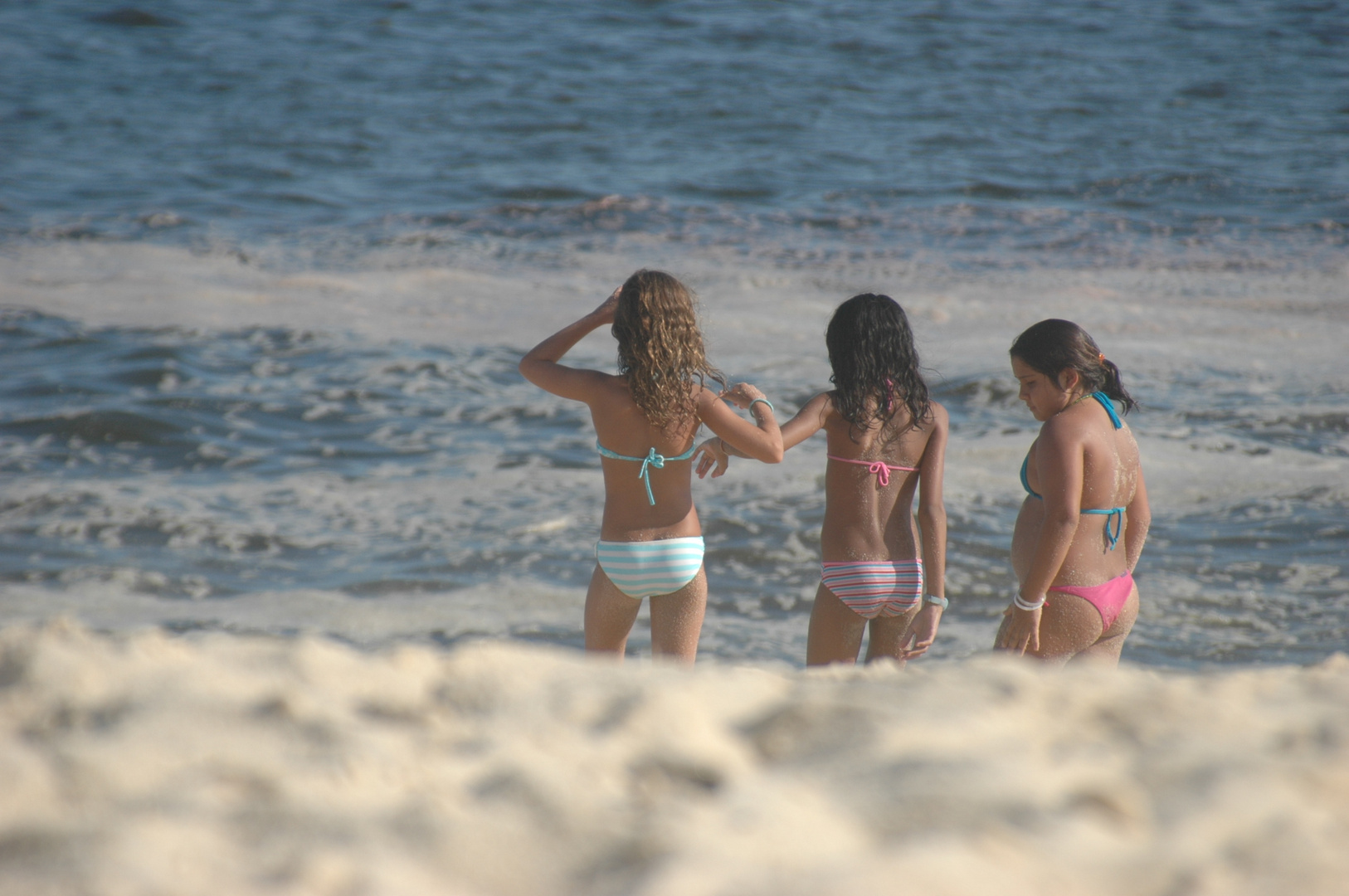 Kids playing close to water on a sunset...