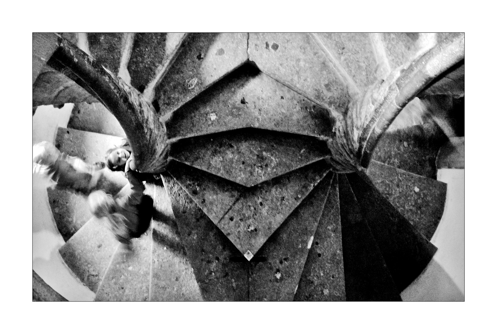 Kids run up the gothic stair - full of joy, with blowing hair