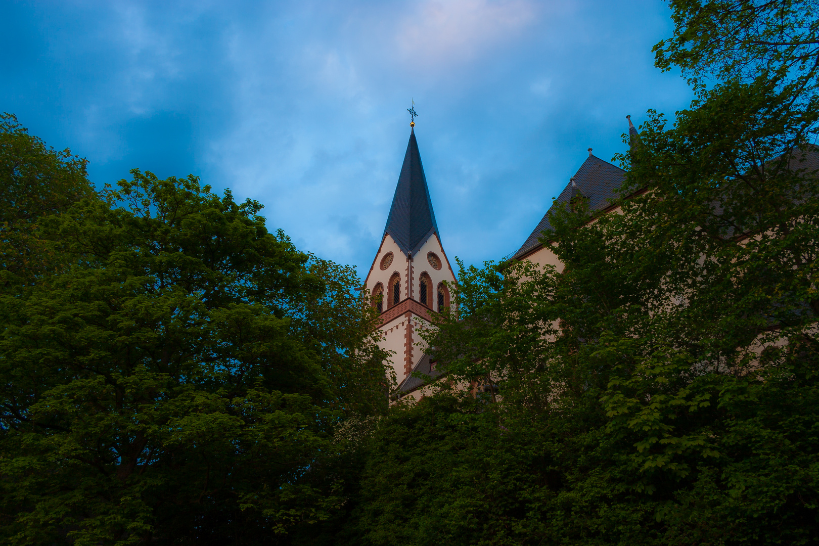 Kirchturmspitze unter einem dunklem Himmel