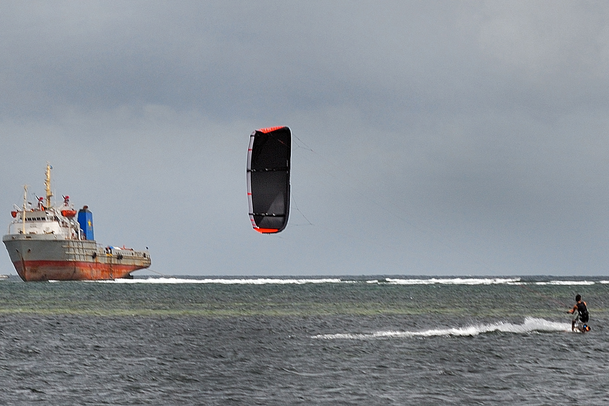 Kite surfing and a ship that's going nowhere