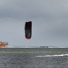 Kite surfing and a ship that's going nowhere