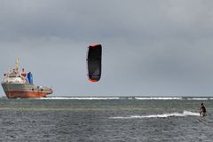 Kite surfing and a ship that's going nowhere