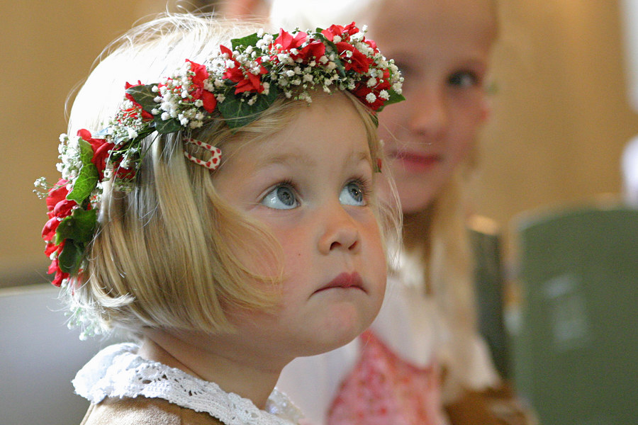 Kleine Blumenstreuerin während der kirchlichen Trauung