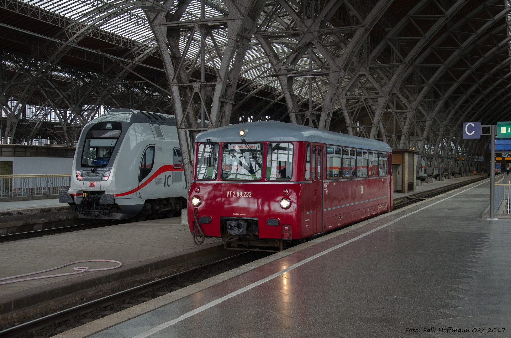 Kleiner Triebwagen in großem Bahnhof