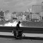 La Habana X, ...lone street sweeper on Malecon.