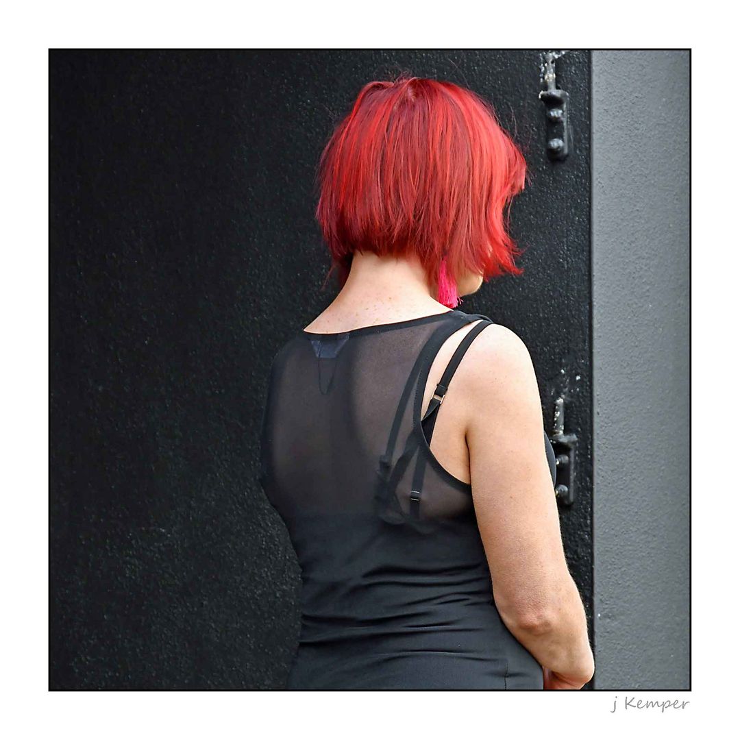 - lady in black with red hair -