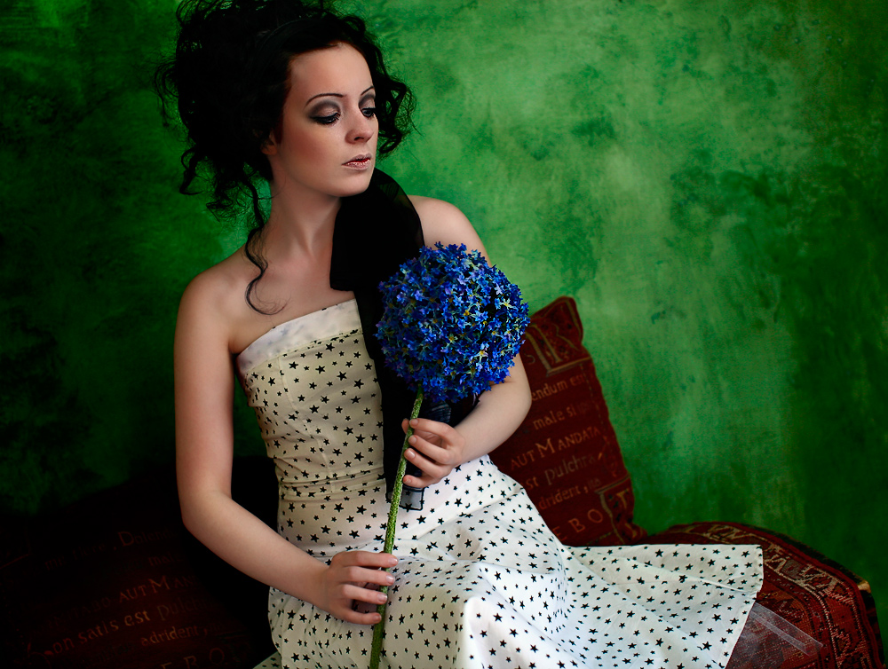 Lady In The Green Room With The Blue Flower