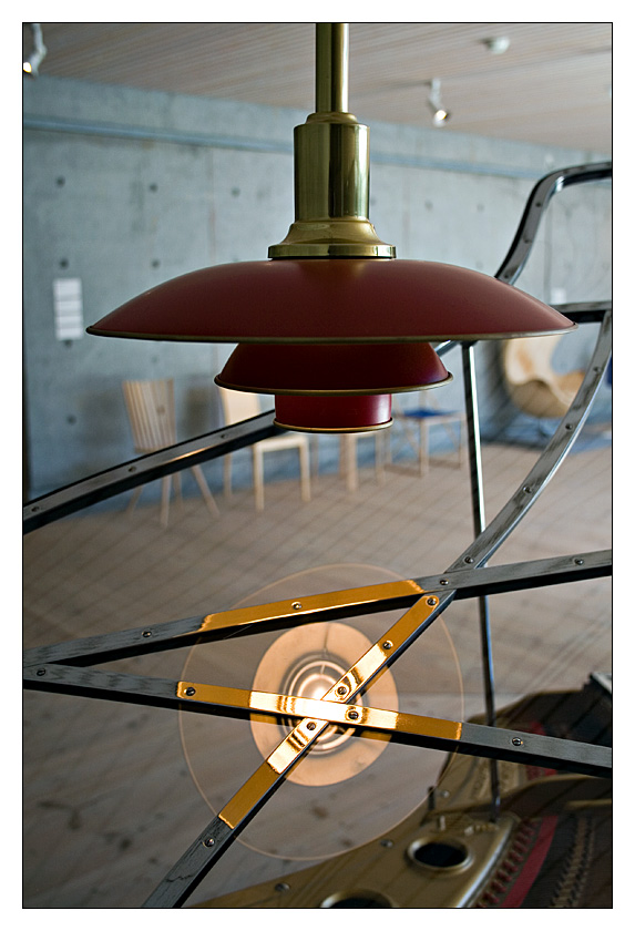 - Lampe mit Spiegelung vor Beton über Poul Henningsen Piano -