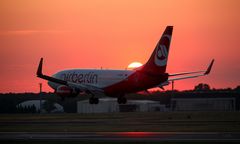 Landing of plane at sundown sunset