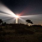 Landschaft mit Leuchtturm bei Nacht