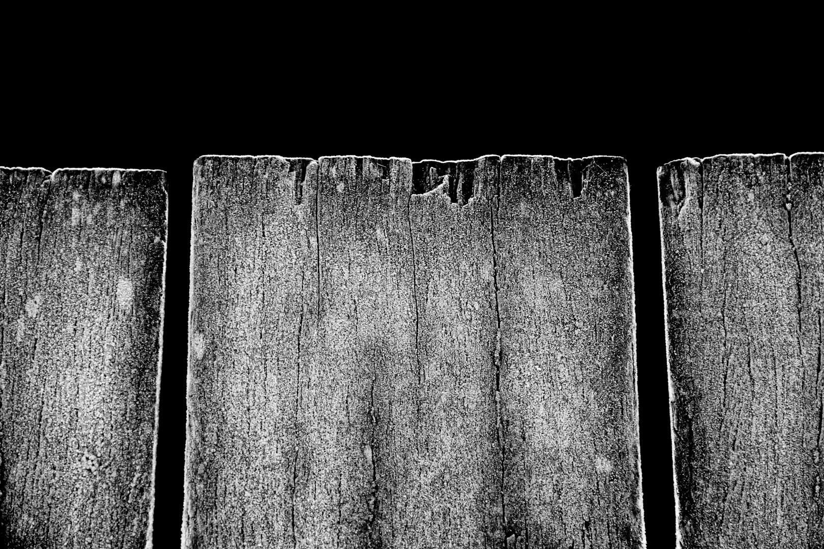 light ground frost on bridge plank ends over a small river