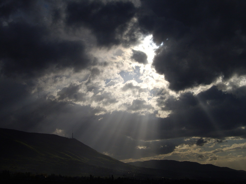 light rays breaking through the storm