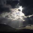 light rays breaking through the storm