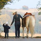 Little cowboy and cowgirl with horse