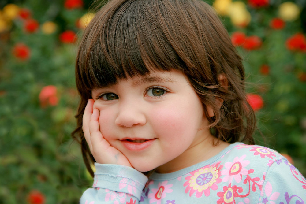 Little girl in a rose garden