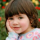 Little girl in a rose garden